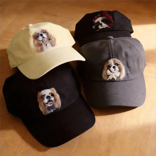 Handmade personalized dog portrait dad hats group display, showcasing adjustable washed cotton baseball caps with unique custom wool felted puppy charms for Cavalier lovers.