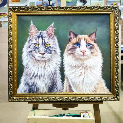 A bespoke, 100% hand-painted oil portrait of a Maine Coon and a Ragdoll cat, displayed in an ornate gold frame, created as a custom pet keepsake by Muse & Paw.