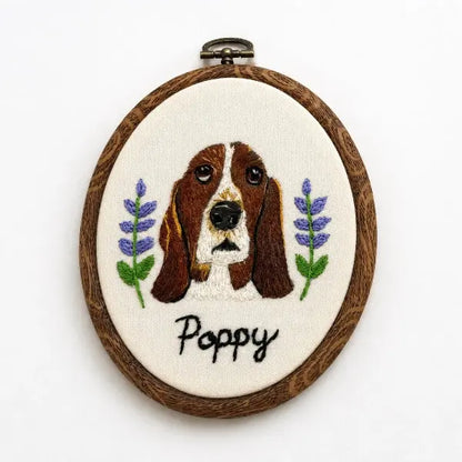 Personalized handmade hound dog head needlework on cream canvas, styled as a vintage oval wall hanging keepsake with custom black text for a unique basset hound mom gift.