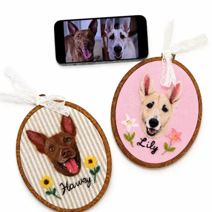 Handmade personalized double dog portrait hoop art featuring custom wool felted dog heads on striped and pink fabrics with embroidered sunflower, lily flowers, and personalized pet names.