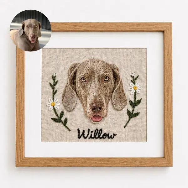 Custom dog photo to embroidery art in a wooden frame, featuring a realistic stitched portrait of a Weimaraner named Willow with floppy ears, amber eyes, and embroidered daisy flowers.