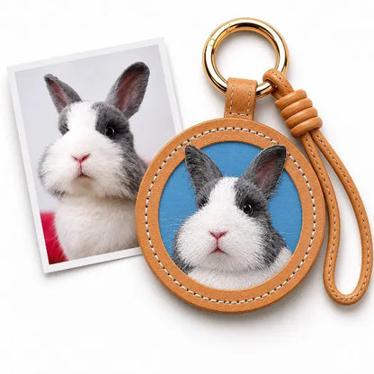 Handmade personalized bunny portrait key ring displaying a premium tan leather tag with a custom painted Dutch rabbit replica, unique luxury pet loss memorial gift.