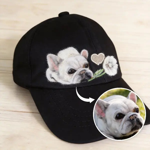 Handmade personalized Frenchie portrait dad hat featuring custom wool felted dog charm, delicate heart and dandelion embroidery on a premium black adjustable baseball cap.