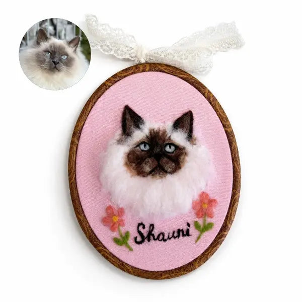 Custom cat photo to felt artwork comparison, showing a circular long-haired Siamese Balinese cat photo transformed into a handmade 3D needle-felted portrait with blue eyes in a wooden oval embroidery hoop.