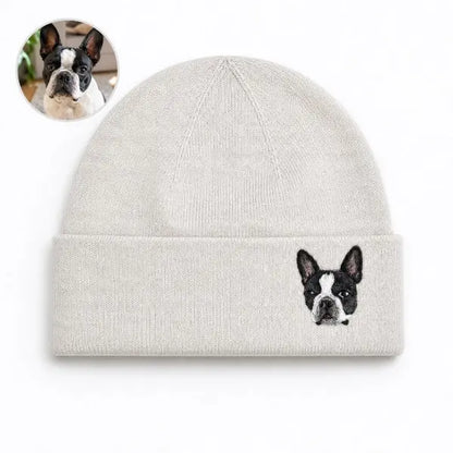Custom dog photo to embroidered beanie comparison, featuring a off-white cuffed knit hat with a detailed realistic embroidered portrait of a black and white Boston Terrier based on the reference photo.