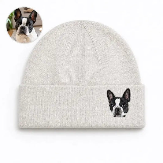 Custom dog photo to embroidered beanie comparison, featuring a off-white cuffed knit hat with a detailed realistic embroidered portrait of a black and white Boston Terrier based on the reference photo.
