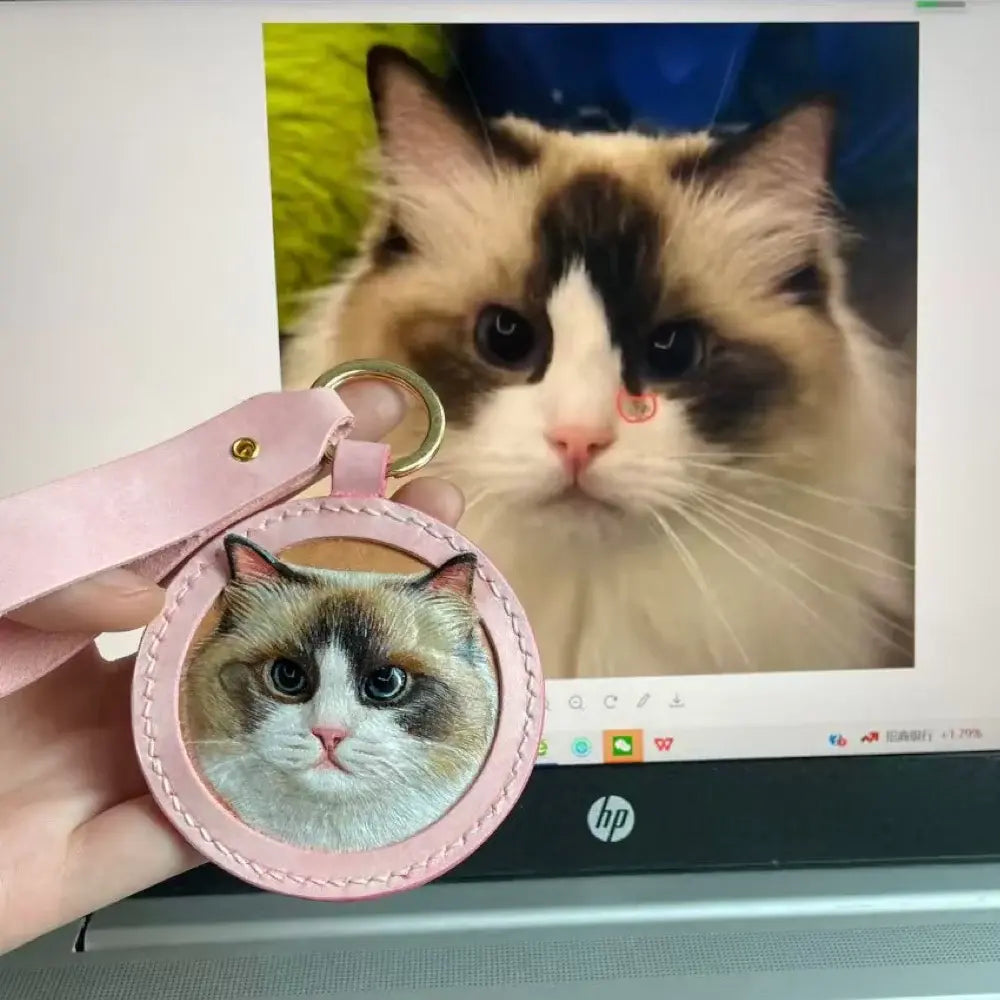 Hand-carved leather Ragdoll cat keychain pendant, custom pet portrait leather bag charm showing comparison with real cat photo by Muse & Paw.