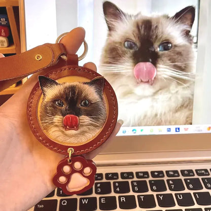 Hand-carved and painted leather Siamese cat keychain pendant, custom pet portrait leather bag charm showing comparison with real cat photo by Muse & Paw.