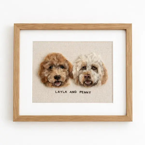 Custom 3D needle-felted pet portrait of two curly-haired dogs, beautifully crafted and displayed in a premium wooden frame.
