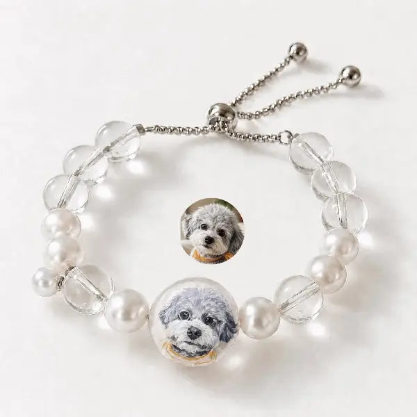 Custom pet photo to jewelry comparison, showing a real grey Poodle dog photo transformed into a hand-painted miniature portrait on a beaded pearl bracelet.
