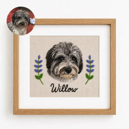 Custom dog photo to embroidery art in a wooden frame, featuring a realistic stitched portrait of a curly grey and black Doodle mix named Willow with detailed fluffy fur texture and embroidered lavender flowers.